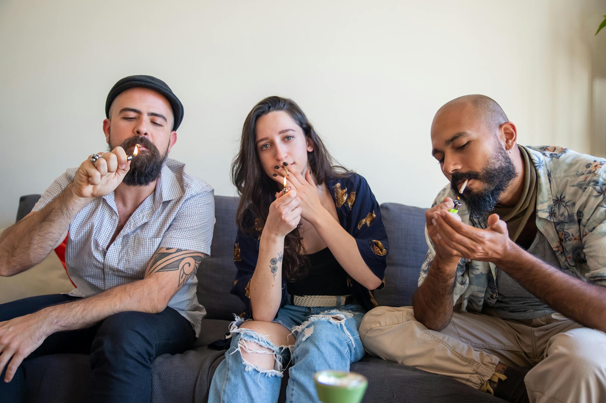 Three adults enjoying a casual indoor gathering, engaging in leisure activities.